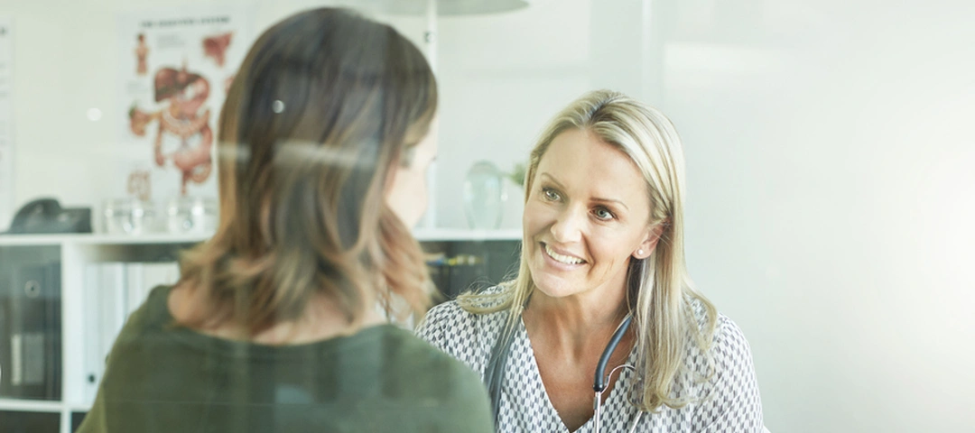 Fertility specialist discussing treatment with a patient during a consultation